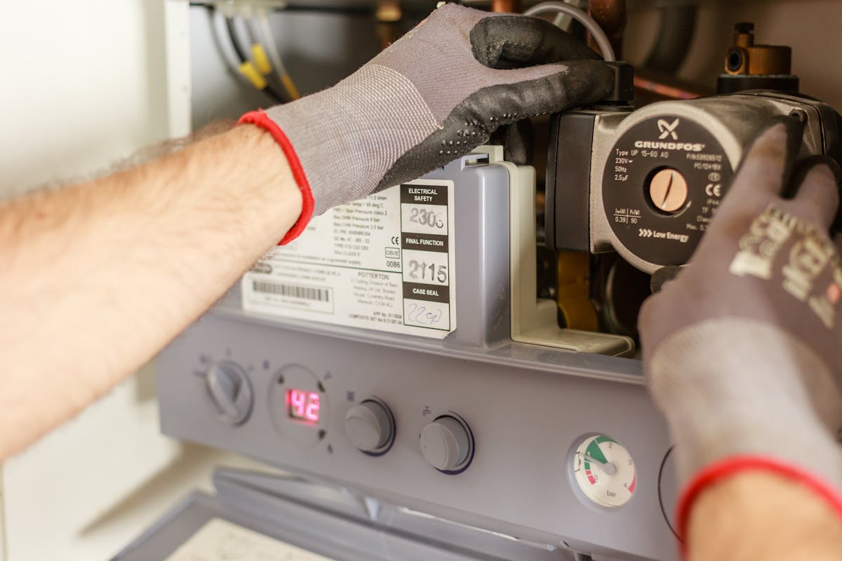Engineer adjusting and diagnosing a boiler system in Greater Manchester