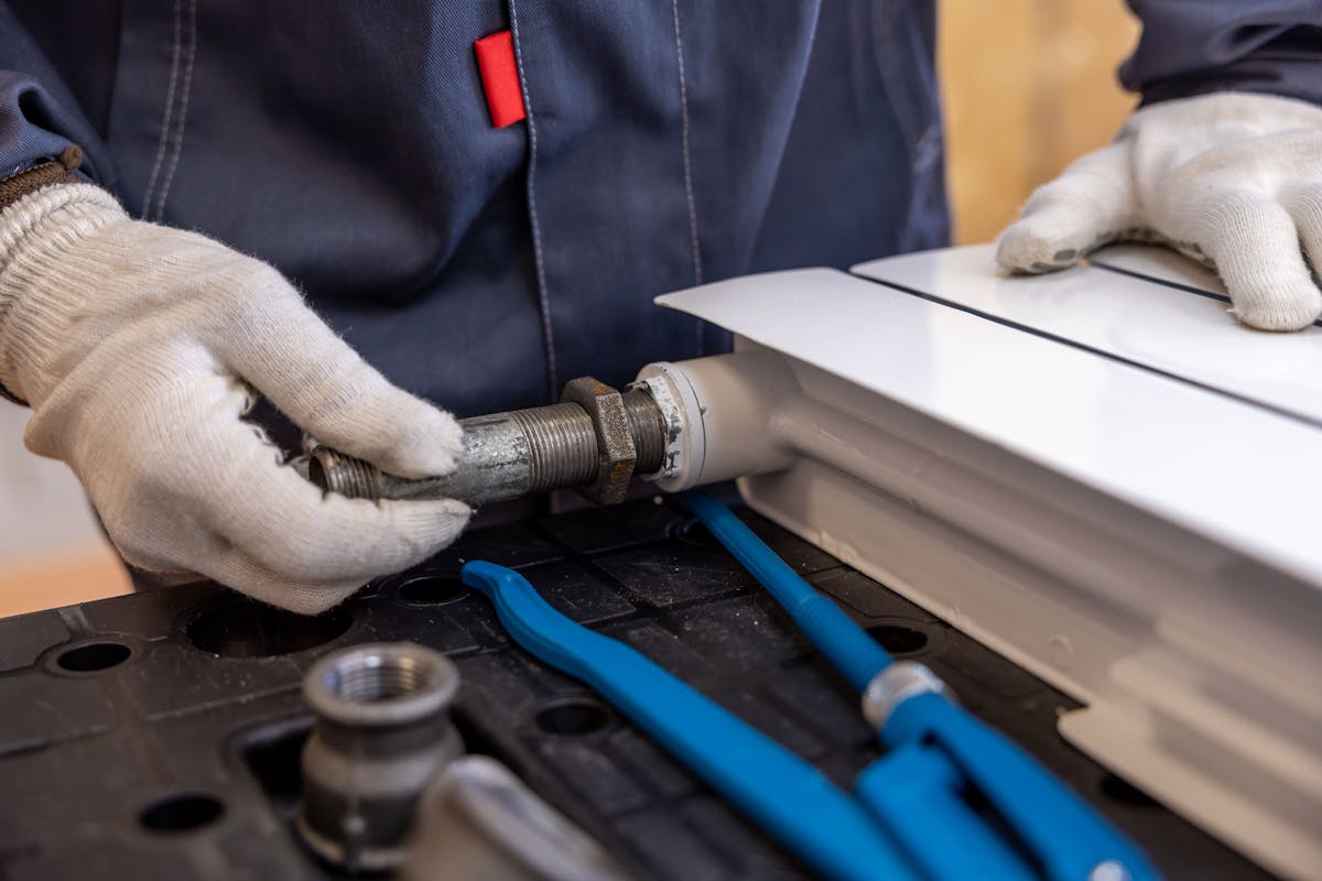 Professional gas engineer carrying out precise pipe installation in a Greater Manchester home